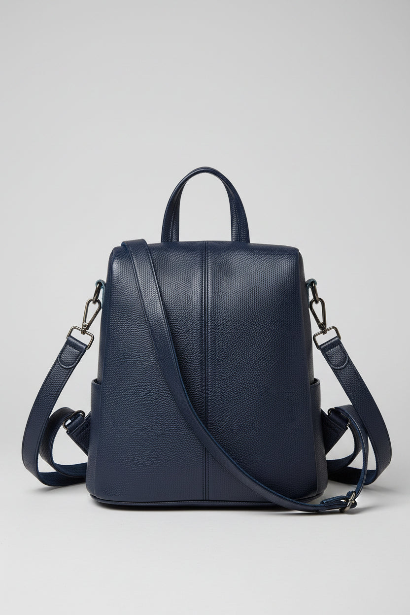 Navy blue backpack on a beige background with text overlay