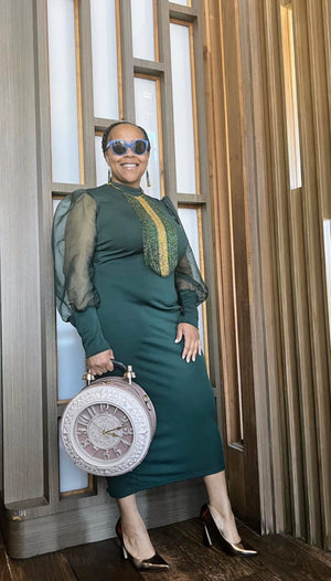 Woman posing holding pink Big clock purse bag